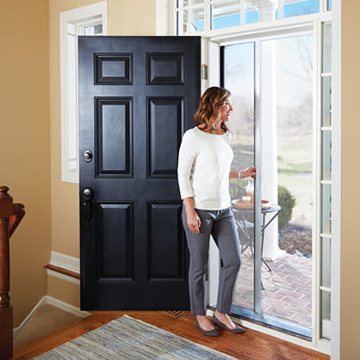 The Luminaire brand of retractable screen doors by Andersen are shown in this home. (Image via the Andersen website)