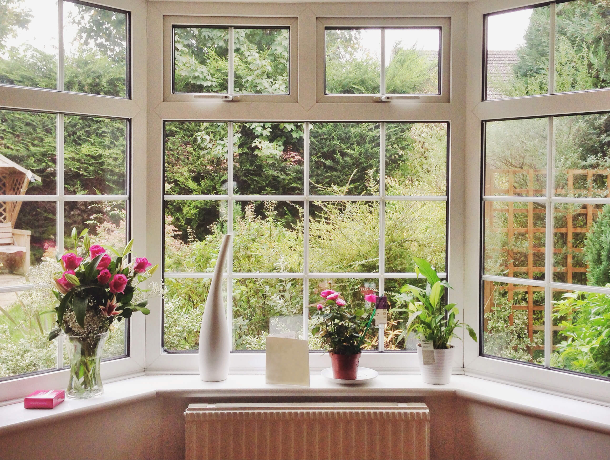Bay window decorated with vases of flowers